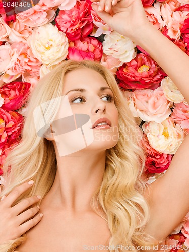 Image of woman and background full of roses
