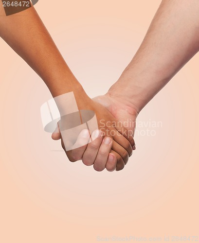 Image of woman and man holding hands