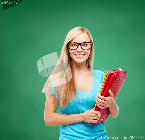 Image of smiling student with folders