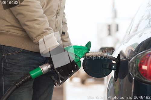 Image of close up of male refilling car fuel tank