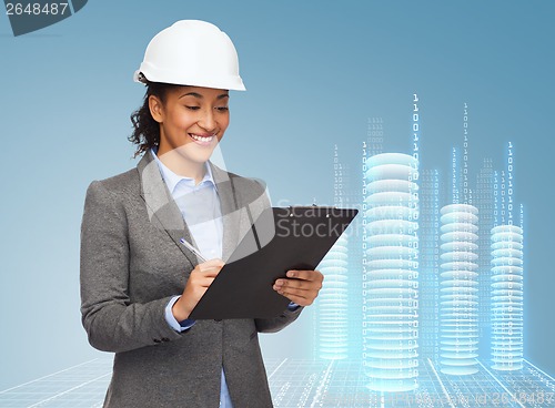 Image of businesswoman in white helmet with clipboard