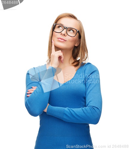 Image of happy woman in black eyeglasses dreaming