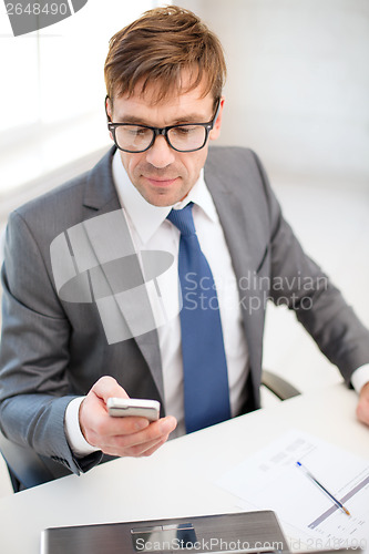 Image of businessman working with laptop and smartphone