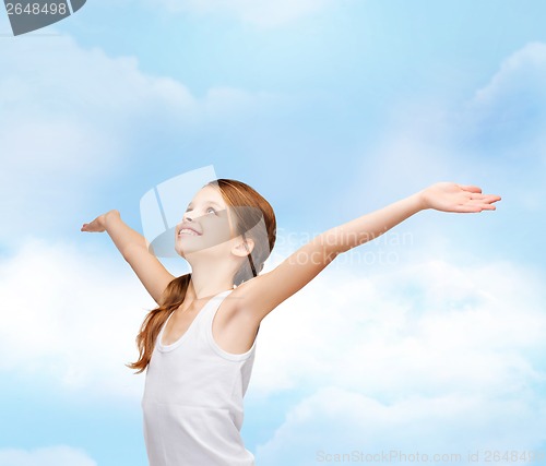 Image of smiling teenage girl with raised hands