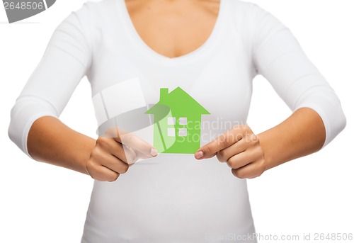 Image of woman hands holding green house