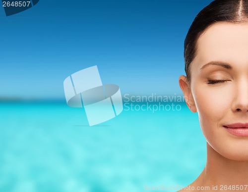 Image of young calm woman with closed eyes