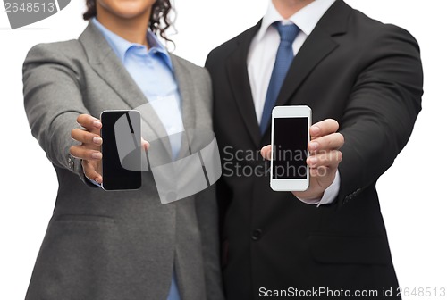 Image of businessman and businesswoman with smartphones