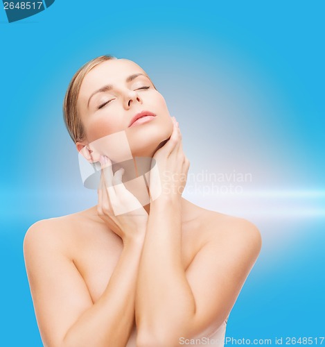 Image of beautiful woman touching her face with closed eyes