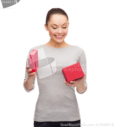 Image of beautiful girl opening red gift box