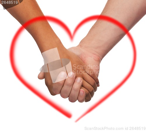 Image of woman and man holding hands