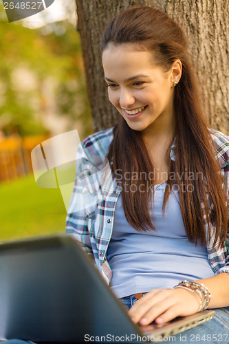 Image of smiling teenager with laptop