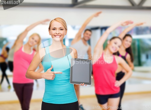 Image of sporty woman with tablet pc blank screen