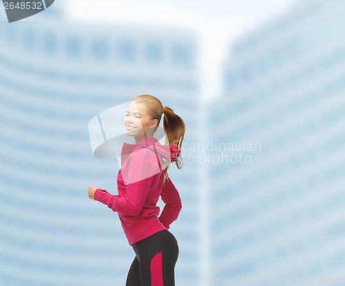 Image of sporty woman running or jumping