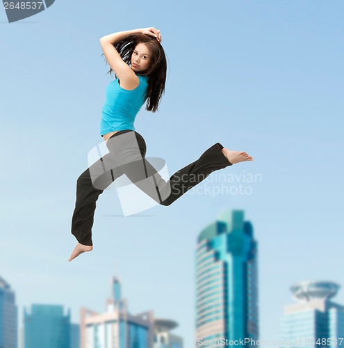 Image of sporty woman jumping in sportswear