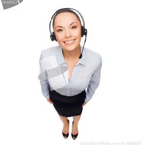 Image of friendly female helpline operator with headphones