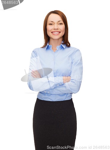 Image of young smiling businesswoman with crossed arms