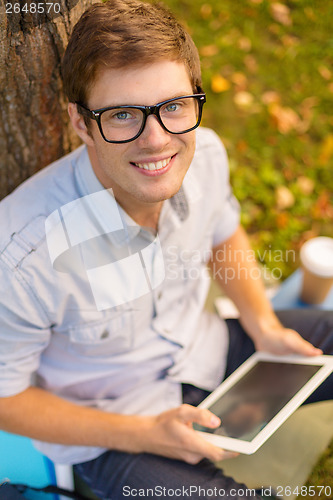 Image of smiling male student in eyeglasses with tablet pc