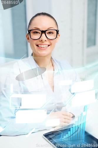 Image of smiling businesswoman in eyeglasses with tablet pc