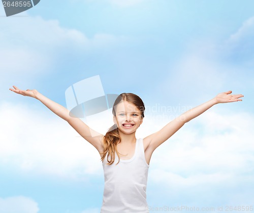 Image of smiling teenage girl with raised hands
