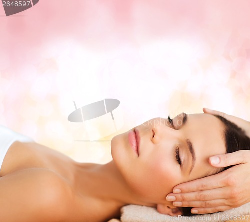 Image of beautiful woman in spa salon having facial