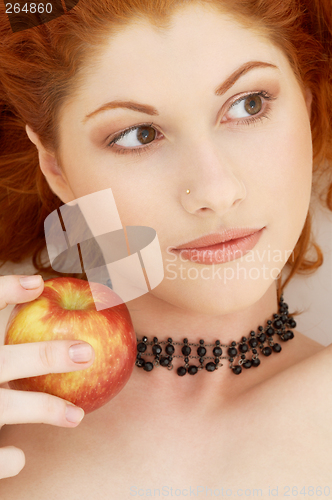 Image of lovely redhead with delicious apple