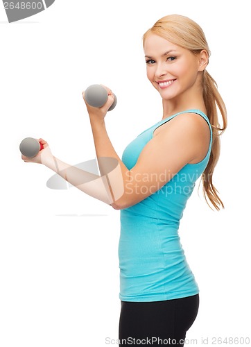 Image of young sporty woman with light dumbbells