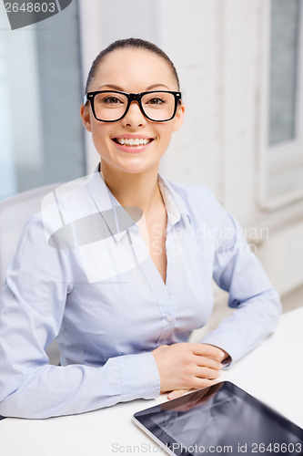 Image of smiling businesswoman in eyeglasses with tablet pc