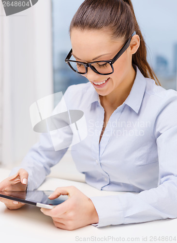 Image of smiling businesswoman in eyeglasses with tablet pc