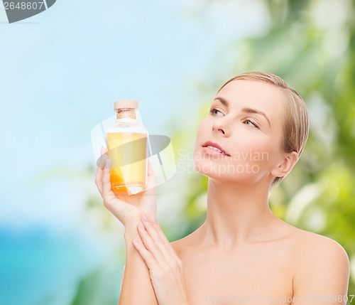 Image of lovely woman with oil bottle