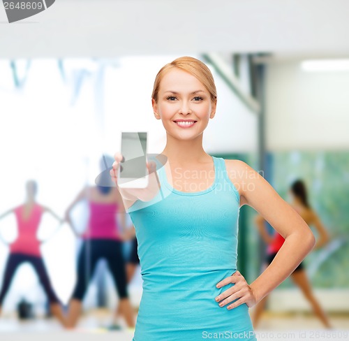 Image of sporty woman with smartphone