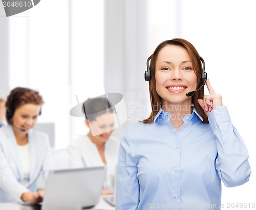 Image of friendly female helpline operator at office