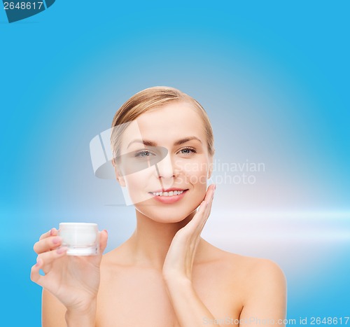 Image of woman applying cream on her skin