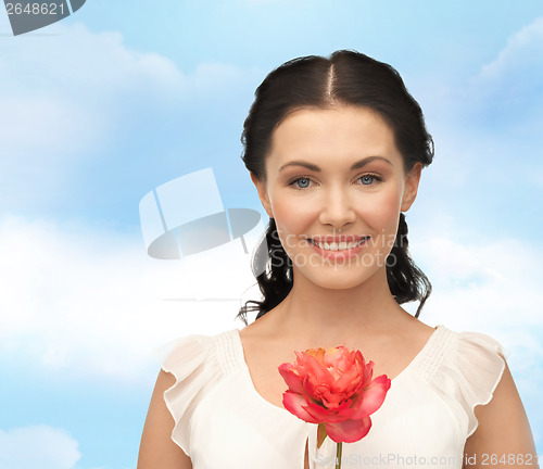 Image of young and beautiful woman with flower