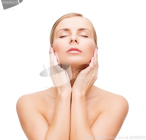 Image of beautiful woman touching her face with closed eyes