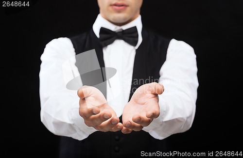 Image of dealer holding something on palms of his hands
