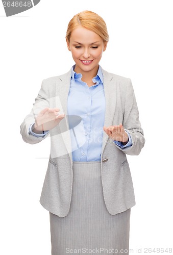 Image of smiling businesswoman pointing to something