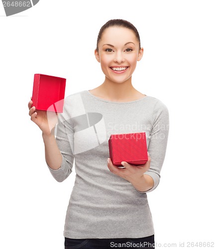 Image of beautiful girl opening red gift box