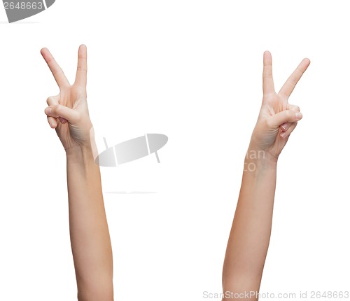 Image of woman hands showing v-sign