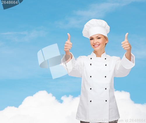 Image of smiling female chef showing thumbs up