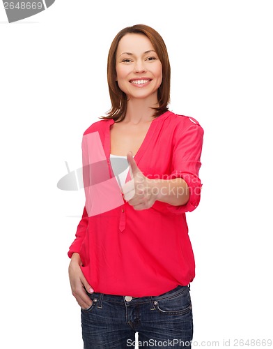 Image of smiling woman showing thumbs up