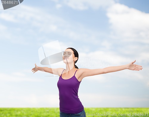 Image of smiling girl in blank purple tank top waving hands