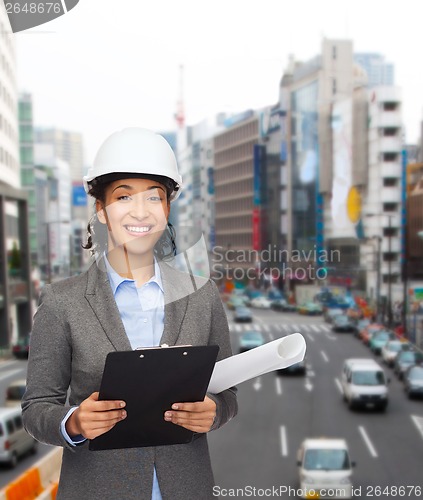 Image of businesswoman in white helmet with clipboard