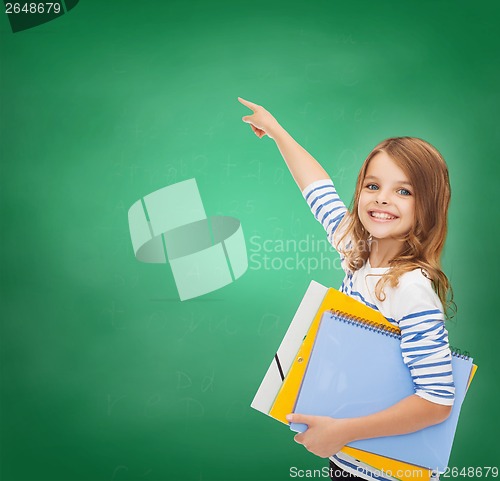 Image of cute girl with folders pointing at virtual screen