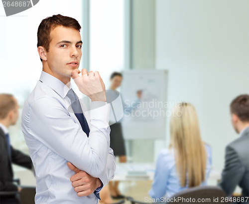 Image of pensive young buisnessman at office