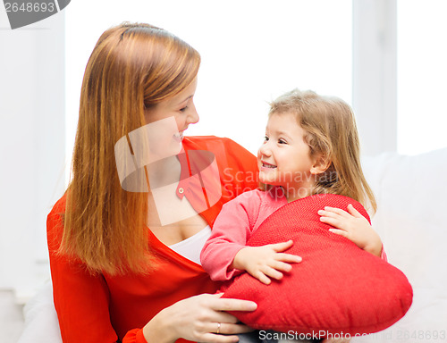 Image of happy mother and child with big red heart at home