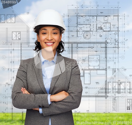 Image of businesswoman in white helmet with crossed arms