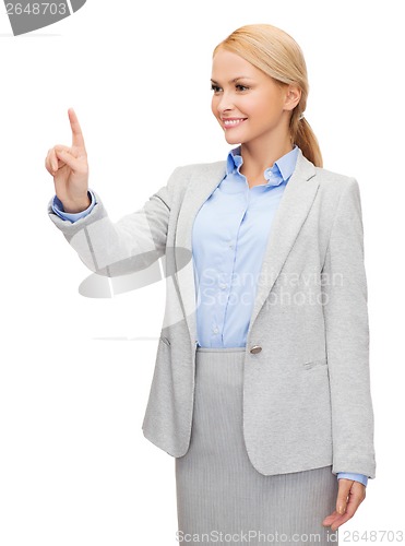 Image of smiling businesswoman working with virtual screen