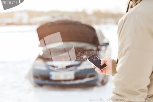 Image of closeup of man with broken car and smartphone