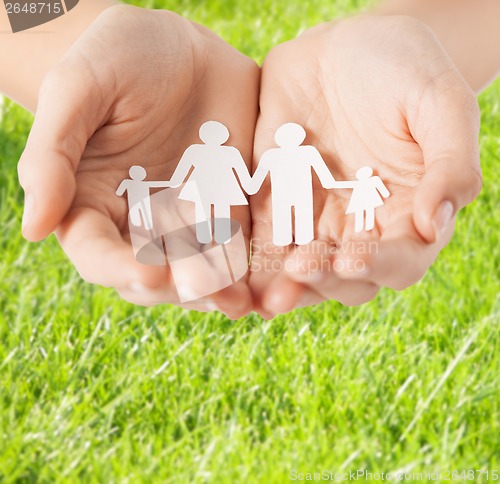 Image of female hands with paper man family