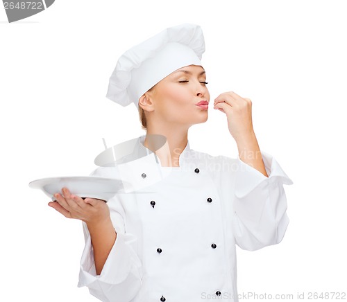Image of female chef with plate showing delicious sign